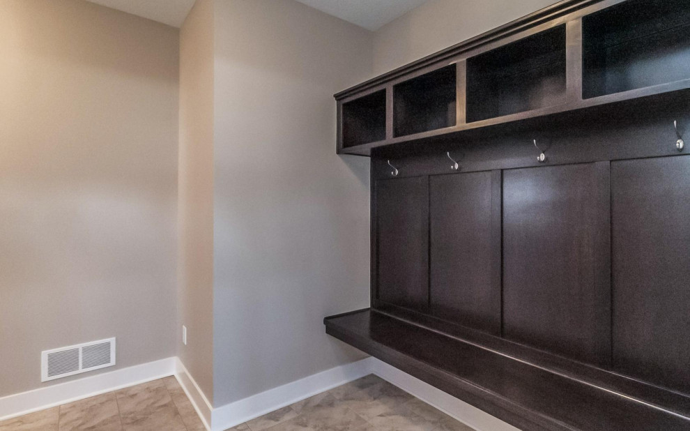Mudroom - transitional medium tone wood floor and brown floor mudroom idea with beige walls and a red front door