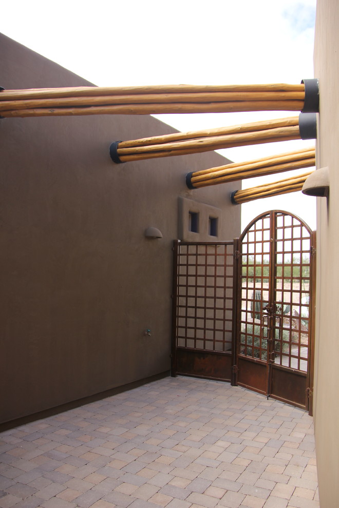 Double front door - large rustic concrete floor double front door idea in Phoenix with brown walls and a glass front door