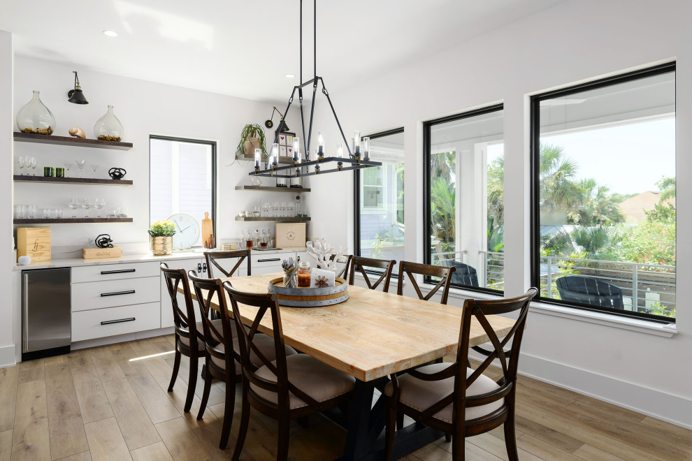 Inspiration for a mid-sized transitional l-shaped vinyl floor and brown floor dining room remodel in Jacksonville with flat-panel cabinets, white cabinets, quartz countertops, white backsplash, quartz backsplash and white countertops