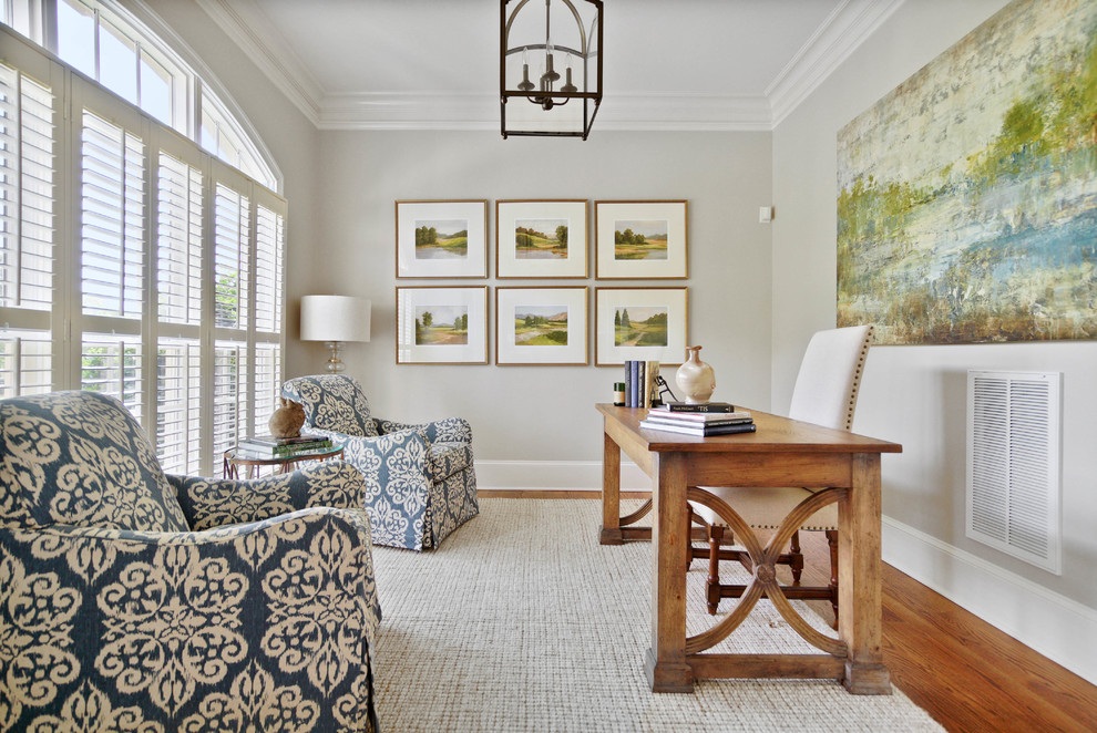 Study room - country freestanding desk medium tone wood floor and brown floor study room idea in Charlotte with gray walls