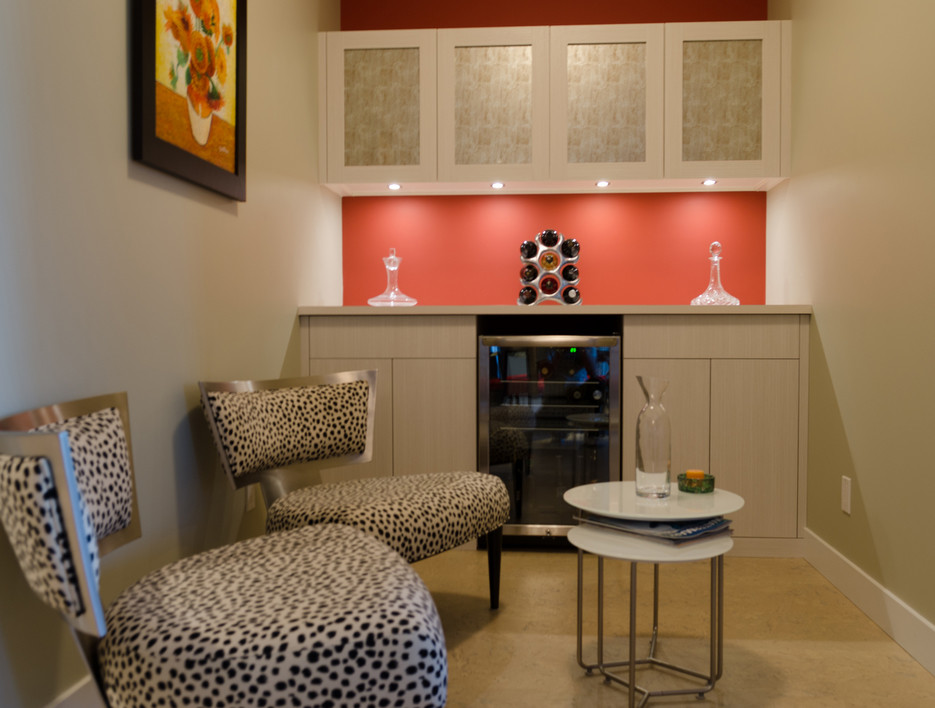 Photo of a small transitional single-wall wet bar in Santa Barbara with flat-panel cabinets, light wood cabinets, wood benchtops, red splashback and porcelain floors.