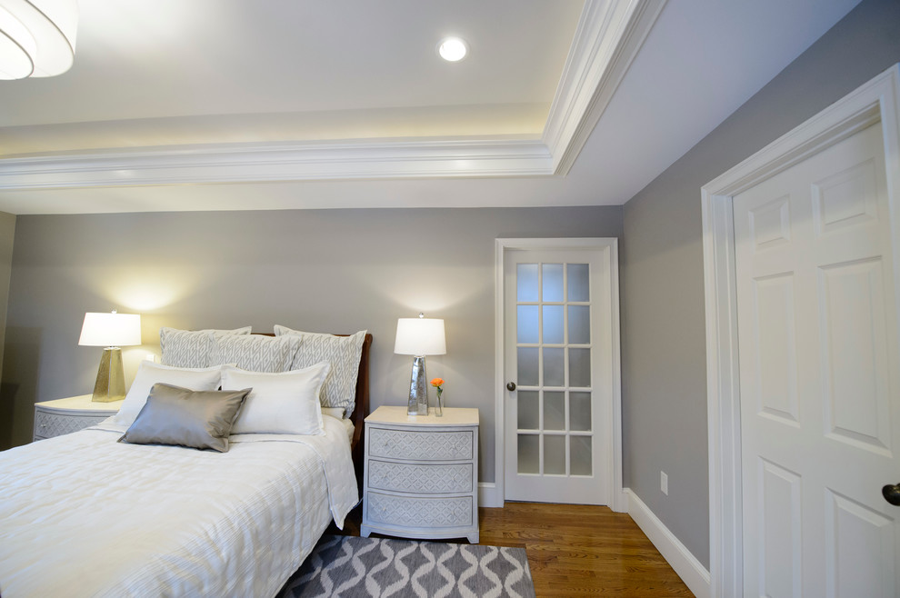 Large transitional master bedroom in Boston with grey walls, medium hardwood floors and no fireplace.