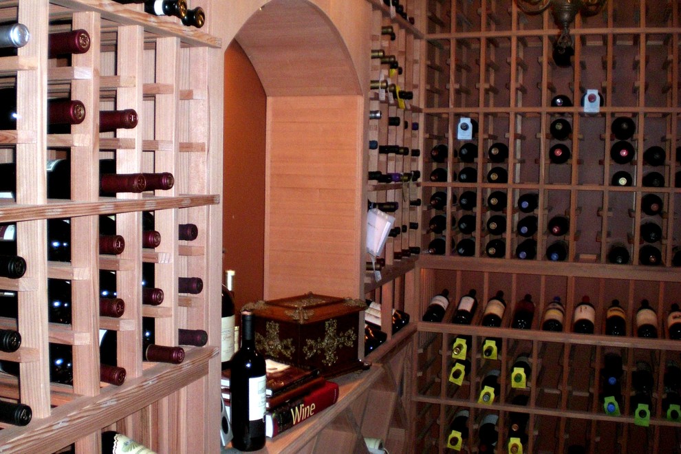 Small transitional wine cellar in Orange County with storage racks.