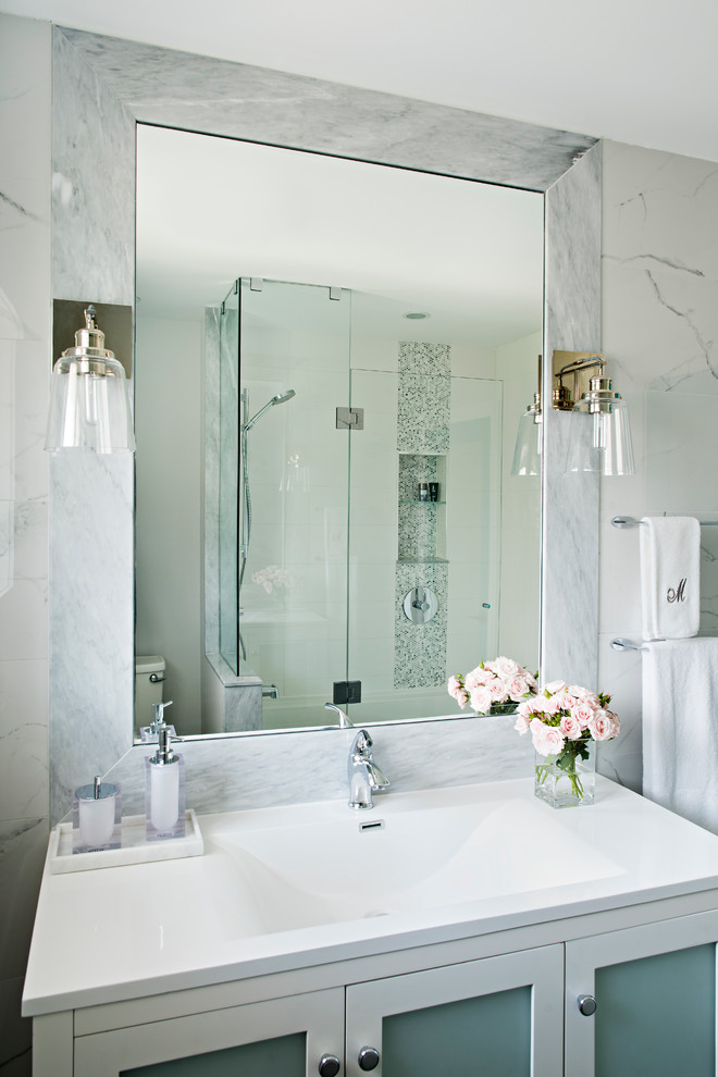 Alcove shower - small transitional white tile and marble tile single-sink alcove shower idea in Raleigh with glass-front cabinets, white cabinets, white walls, an integrated sink, quartzite countertops, a hinged shower door, white countertops and a freestanding vanity