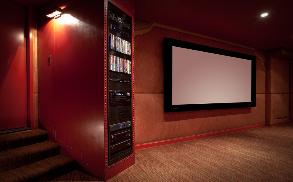 Inspiration for a large mediterranean enclosed home theatre in Los Angeles with orange walls, carpet and a projector screen.