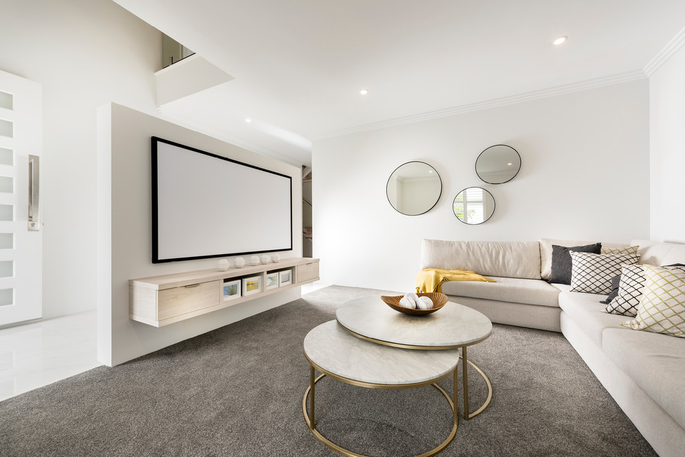 This is an example of a mid-sized modern open concept home theatre in Perth with white walls, carpet and a projector screen.
