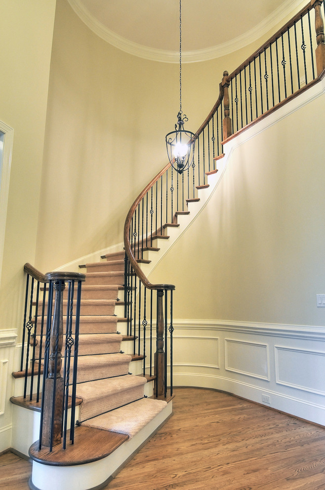 Photo of a mid-sized traditional wood spiral staircase in Charlotte with painted wood risers.