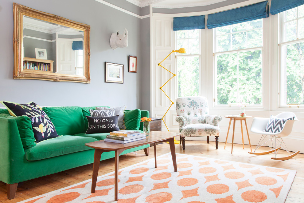 Eclectic open concept living room in Edinburgh with grey walls, light hardwood floors, no tv and beige floor.