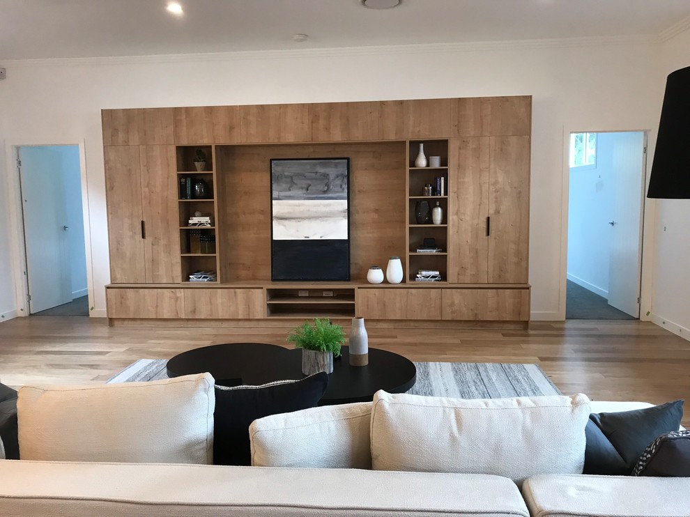 Design ideas for a large contemporary open concept living room in Brisbane with light hardwood floors and a built-in media wall.