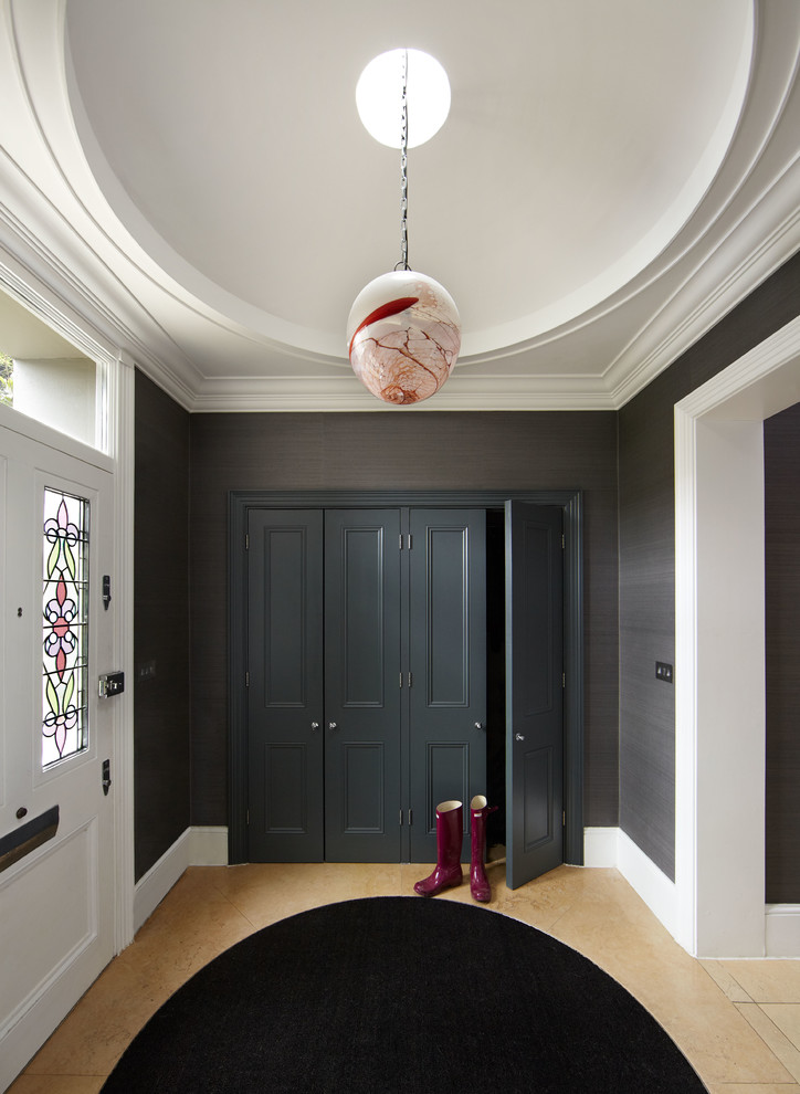 Contemporary mudroom in London with a white front door.