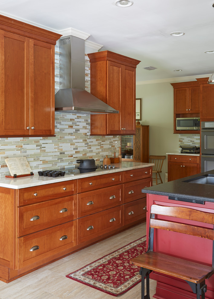 Inspiration for a large traditional kitchen in Jacksonville with an undermount sink, shaker cabinets, red cabinets, granite benchtops, beige splashback, glass tile splashback, stainless steel appliances, travertine floors and with island.