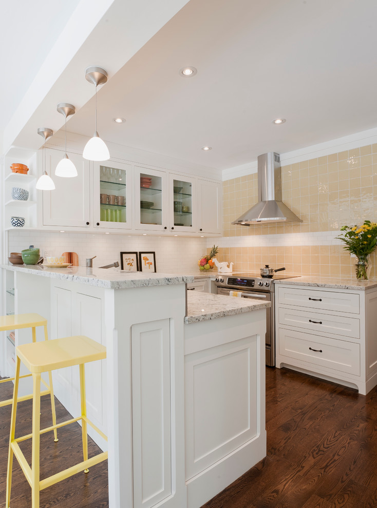 Inspiration for a traditional u-shaped eat-in kitchen in Toronto with an undermount sink, shaker cabinets, white cabinets, granite benchtops, white splashback, mosaic tile splashback and stainless steel appliances.