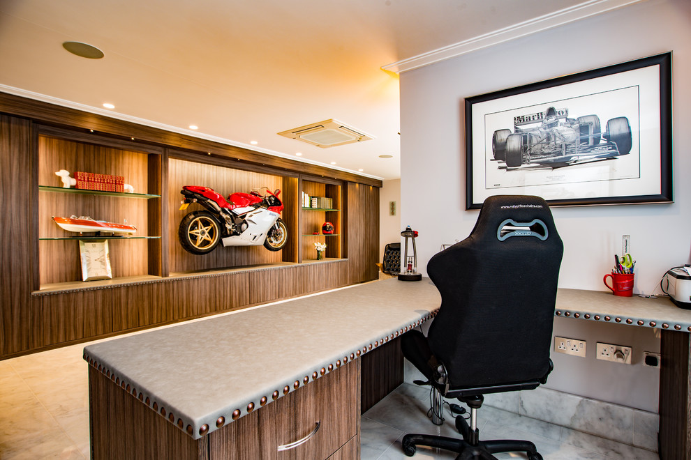 This is an example of a contemporary home office in Buckinghamshire with marble floors and white floor.