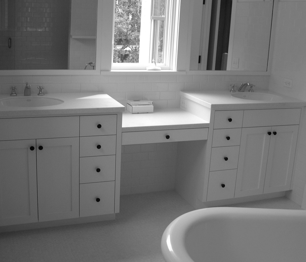 Design ideas for a mid-sized transitional master bathroom in Denver with an undermount sink, shaker cabinets, white cabinets, solid surface benchtops, a freestanding tub, white tile, ceramic tile, white walls and mosaic tile floors.