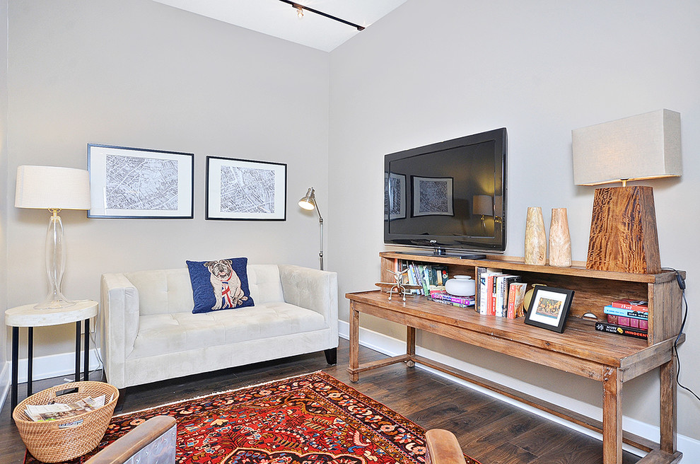 Small contemporary open concept family room in Ottawa with white walls, dark hardwood floors and a freestanding tv.
