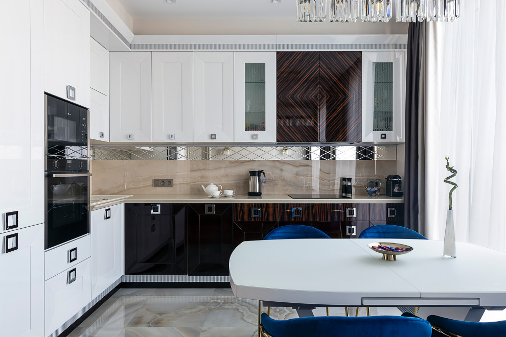 This is an example of a mid-sized transitional l-shaped open plan kitchen in Moscow with a drop-in sink, recessed-panel cabinets, white cabinets, quartz benchtops, beige splashback, porcelain splashback, panelled appliances, porcelain floors, no island, white floor, beige benchtop and recessed.