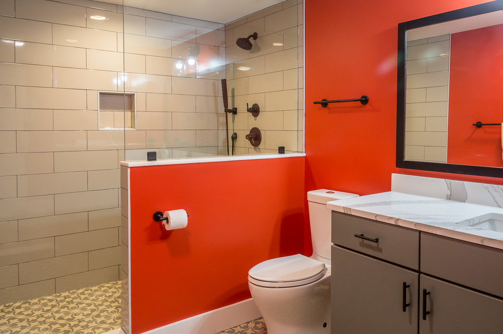 Photo of a mid-sized contemporary 3/4 bathroom in Other with flat-panel cabinets, grey cabinets, an alcove shower, a two-piece toilet, orange tile, ceramic tile, orange walls, light hardwood floors, an undermount sink, granite benchtops, beige floor and white benchtops.