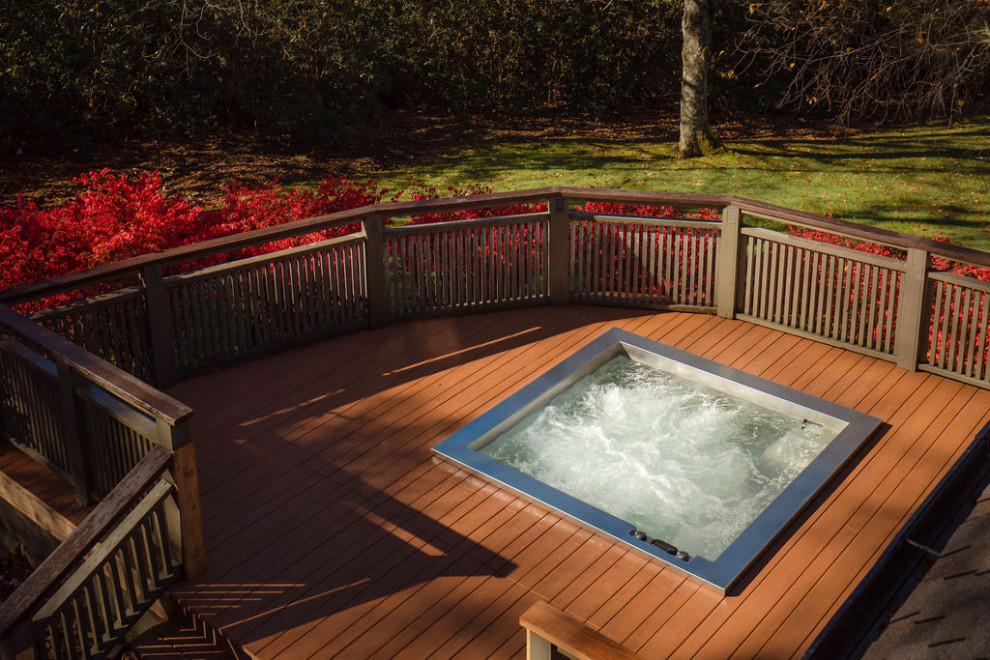 Hot tub - small rustic backyard rectangular aboveground hot tub idea in Other with decking