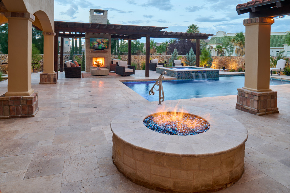 Inspiration for a mid-sized mediterranean backyard patio in Other with a fire feature, natural stone pavers and a pergola.