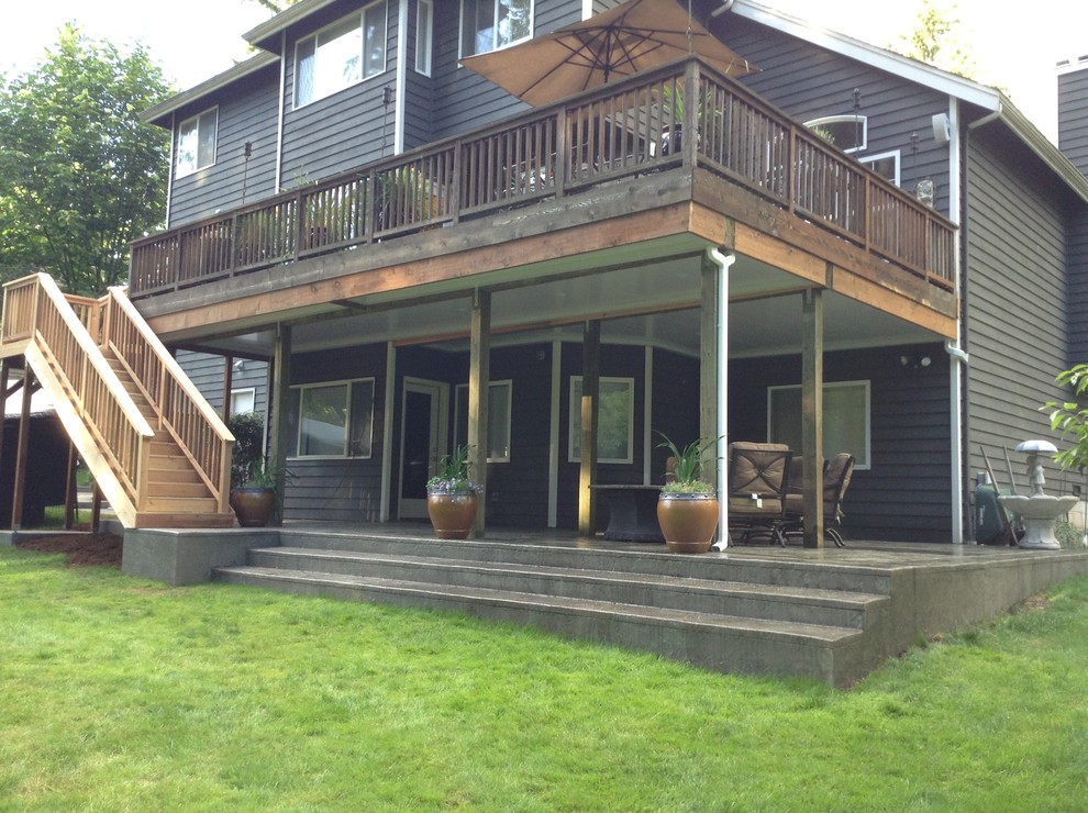 Inspiration for a mid-sized transitional backyard stamped concrete patio remodel in Seattle with a fire pit