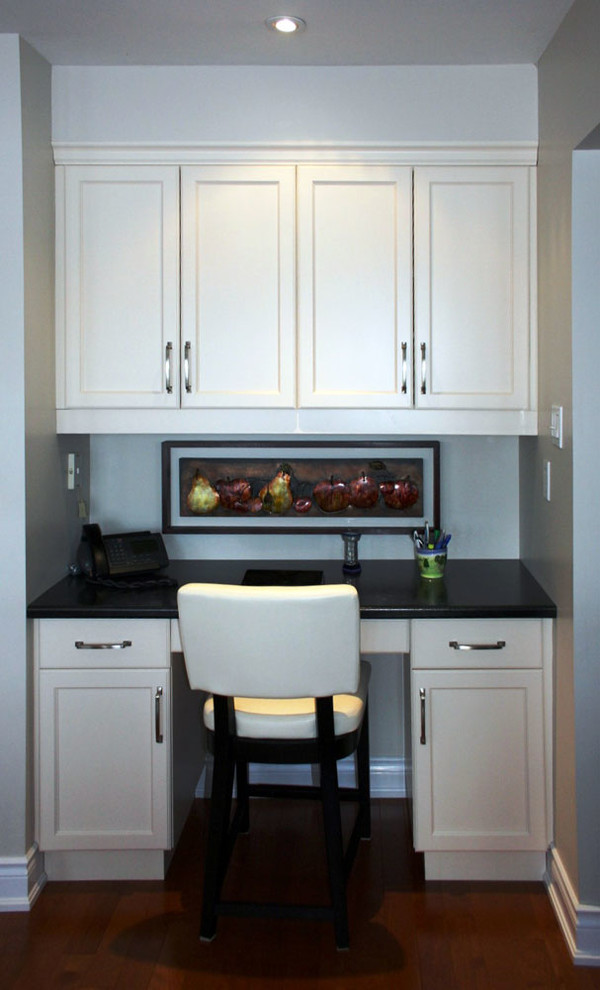 Example of a mid-sized transitional single-wall medium tone wood floor eat-in kitchen design in Toronto with shaker cabinets, white cabinets, laminate countertops and no island