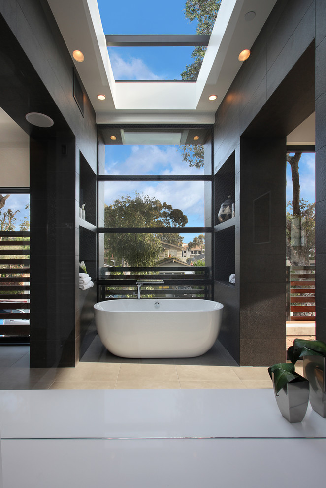 Trendy master freestanding bathtub photo in Orange County with open cabinets and black cabinets
