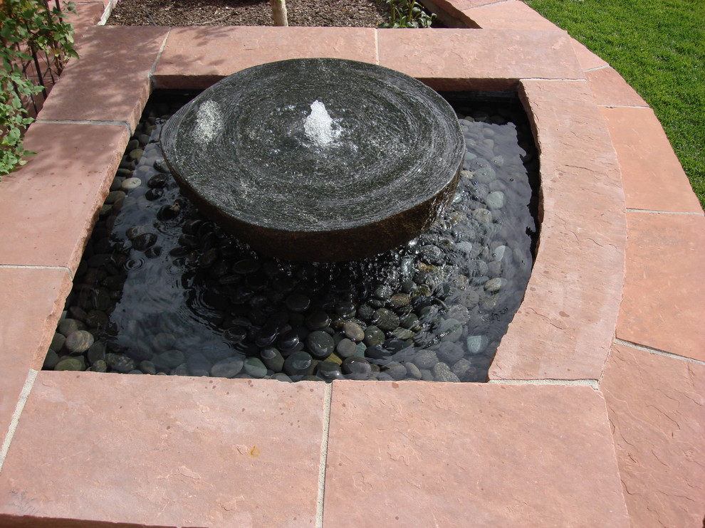 Photo of a small arts and crafts backyard partial sun garden for summer in Denver with a water feature and natural stone pavers.