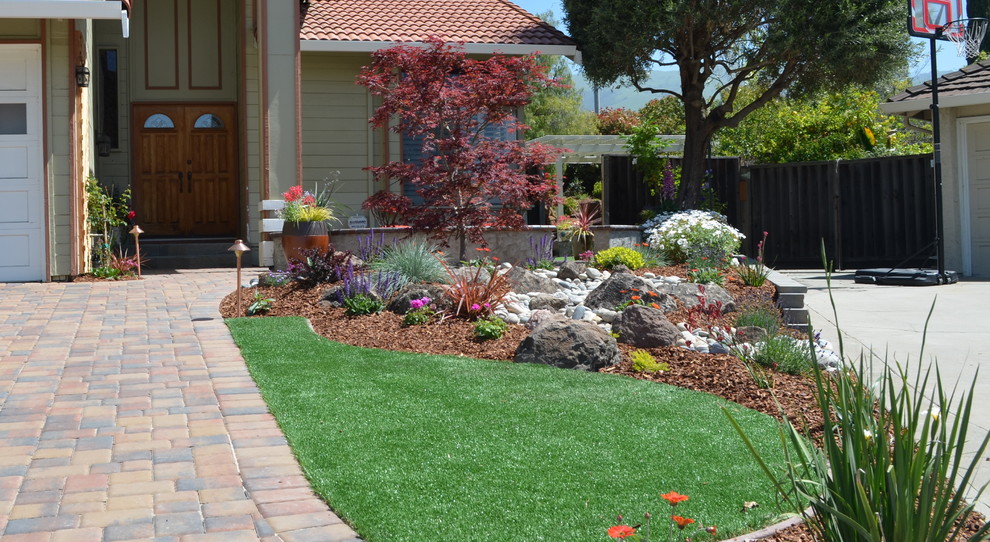Design ideas for a mid-sized asian front yard partial sun garden for spring in San Francisco with natural stone pavers.