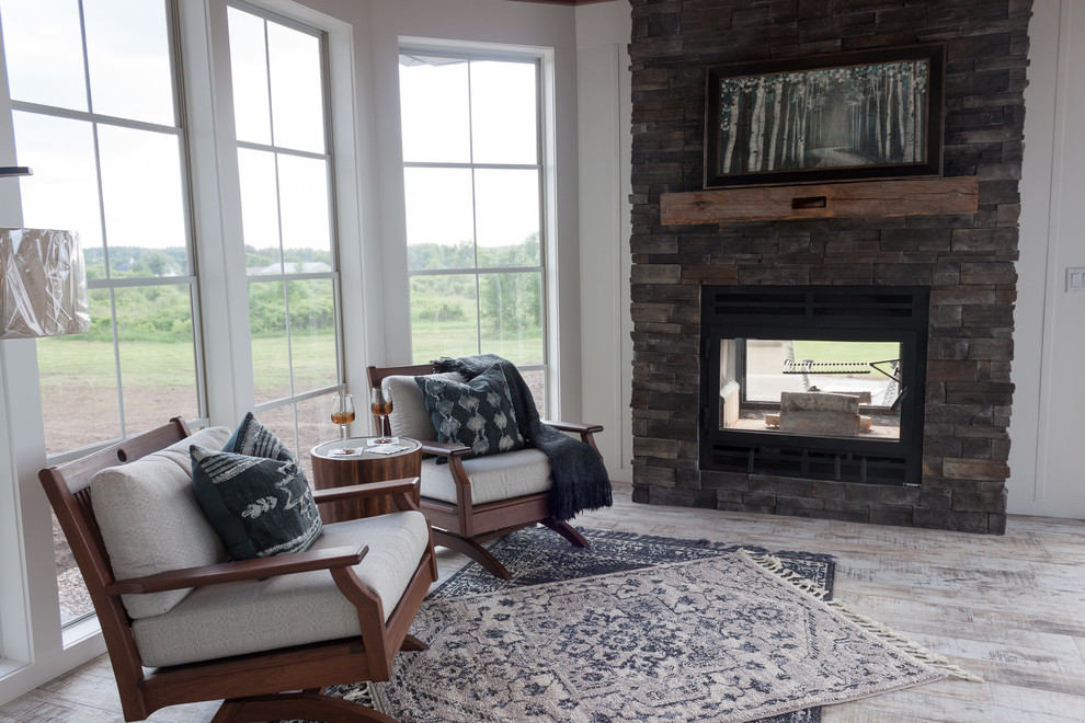 Transitional sunroom in Other with a two-sided fireplace and a stone fireplace surround.