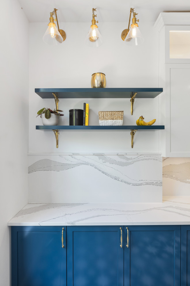 Mid-sized contemporary u-shaped kitchen pantry in New York with a farmhouse sink, shaker cabinets, blue cabinets, marble benchtops, white splashback, marble splashback, stainless steel appliances, porcelain floors, no island, black floor, white benchtop and vaulted.