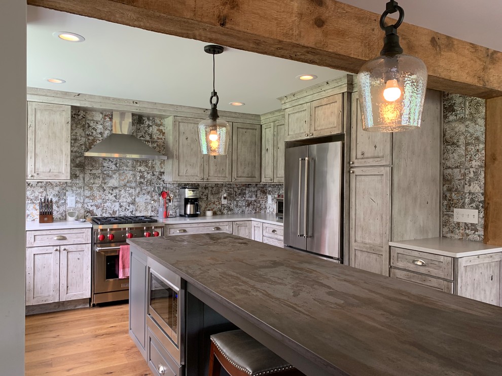 Mid-sized country u-shaped kitchen in Burlington with shaker cabinets, quartzite benchtops, grey benchtop, grey cabinets, medium hardwood floors, with island and brown floor.