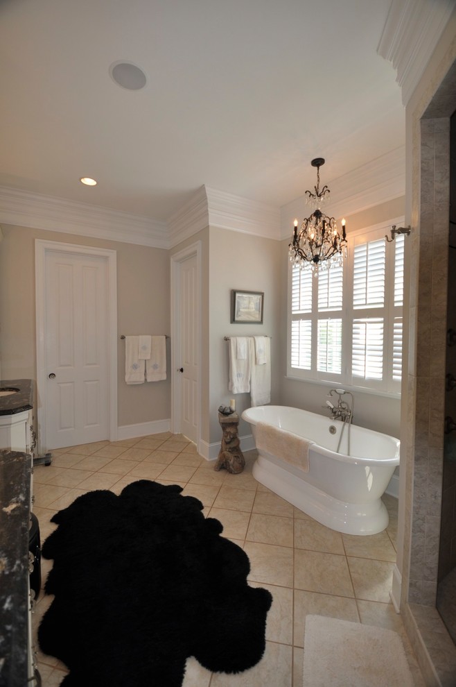 Inspiration for a large traditional master bathroom in Other with recessed-panel cabinets, white cabinets, a freestanding tub, beige walls, porcelain floors, an undermount sink, quartzite benchtops, beige floor and black benchtops.