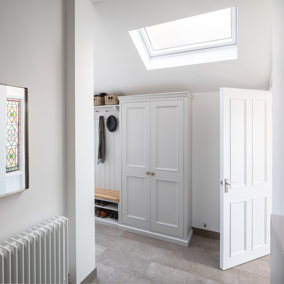 Inspiration for a small contemporary foyer in Other with white walls, porcelain floors, a single front door, a white front door and grey floor.
