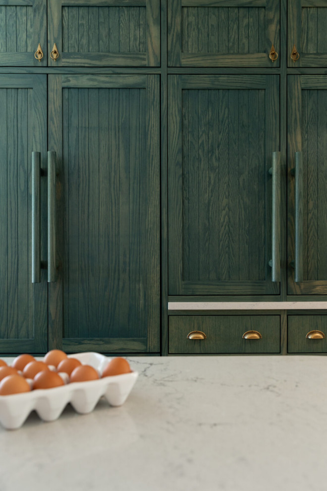 Example of a transitional kitchen design with quartz countertops, white countertops, recessed-panel cabinets, an island and colored appliances