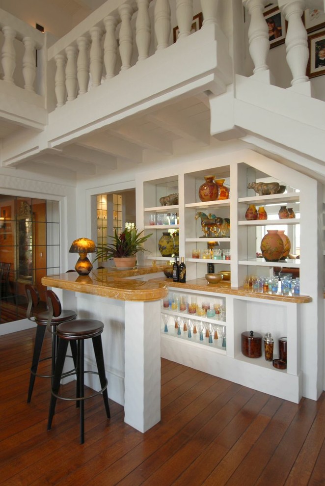 Traditional u-shaped seated home bar in San Francisco with open cabinets, white cabinets, onyx benchtops and medium hardwood floors.
