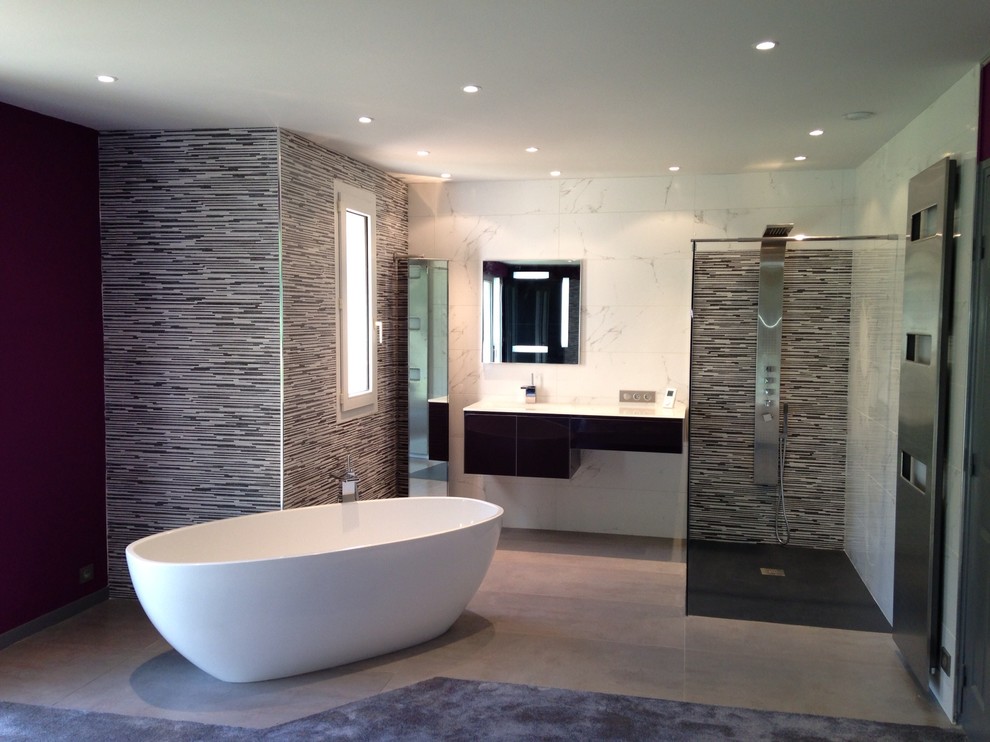 Photo of a large contemporary master wet room bathroom in Montpellier with louvered cabinets, brown cabinets, a freestanding tub, a bidet, beige tile, marble, multi-coloured walls, porcelain floors, a trough sink, tile benchtops, multi-coloured floor, an open shower and white benchtops.
