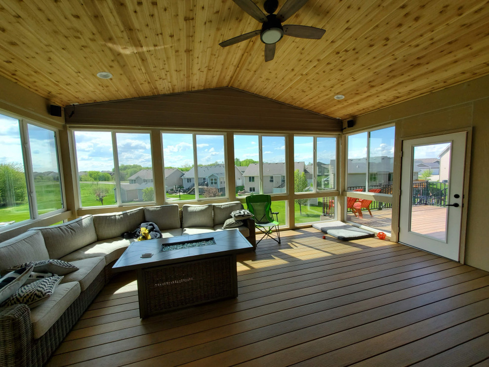 Inspiration for a large backyard second story metal railing deck remodel with a roof extension
