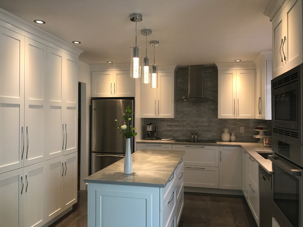 Photo of a large transitional l-shaped kitchen in Montreal with an undermount sink, white cabinets, grey splashback, stainless steel appliances and with island.
