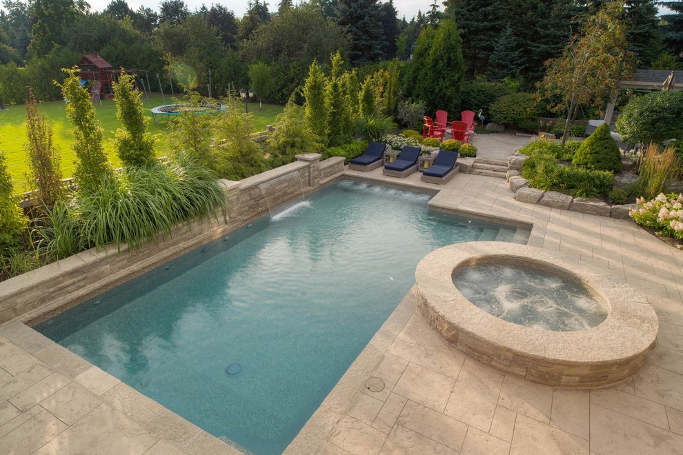 Inspiration for a mid-sized transitional backyard stamped concrete and rectangular hot tub remodel