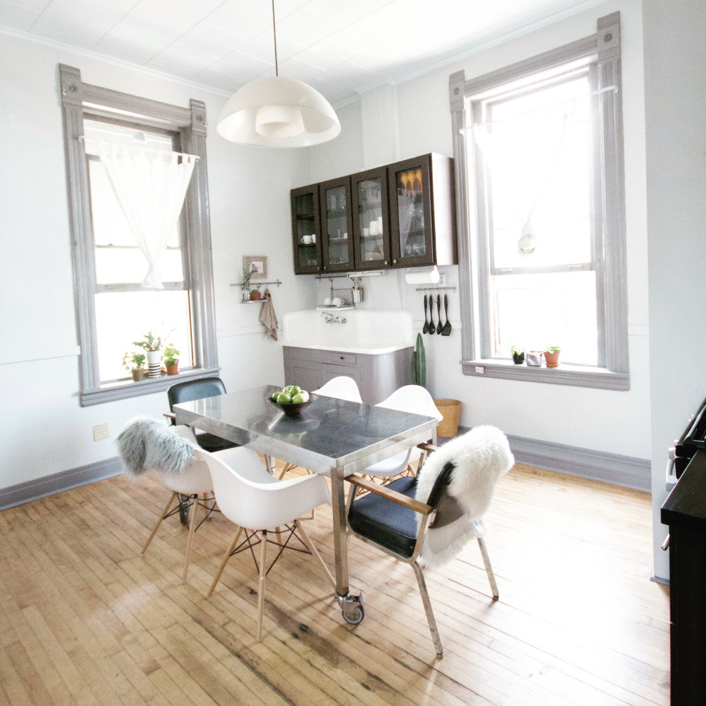 A bright, slightly-mismatched dining table and hardwood floor