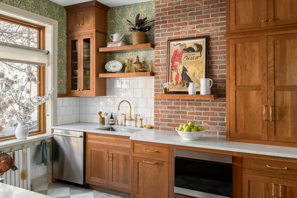 Inspiration for a small traditional galley separate kitchen in Philadelphia with an undermount sink, shaker cabinets, medium wood cabinets, quartz benchtops, white splashback, subway tile splashback, stainless steel appliances, marble floors, no island, grey floor and white benchtop.