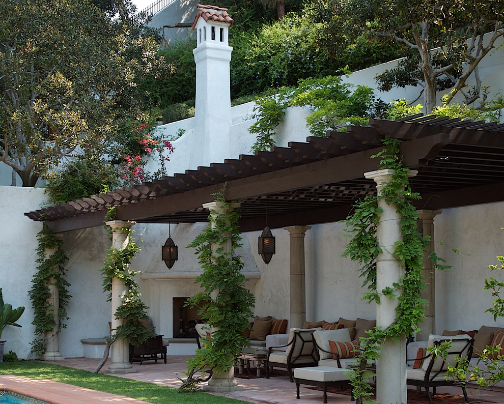 Photo of a mediterranean patio in Los Angeles with a fire feature and a pergola.