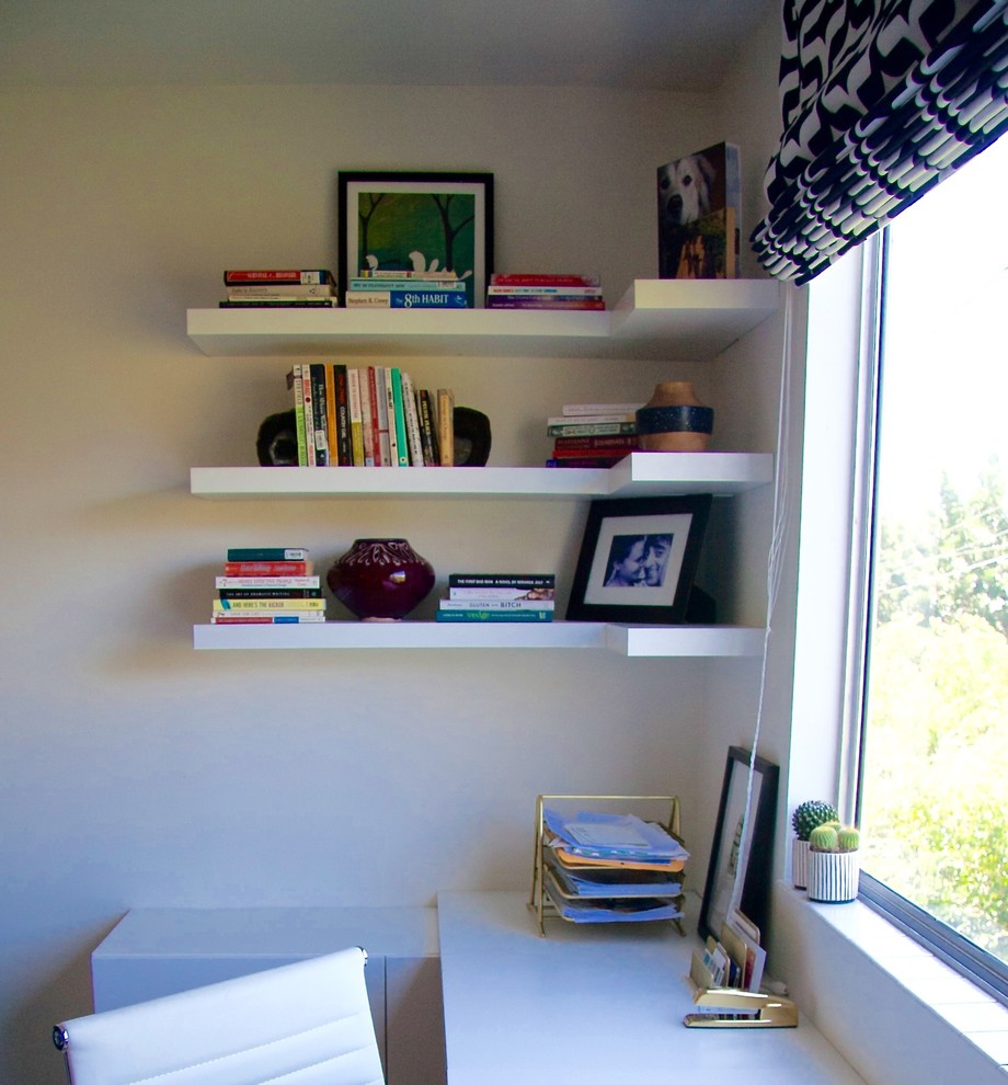 Photo of a small modern study room in Los Angeles with white walls, carpet, a built-in desk and beige floor.