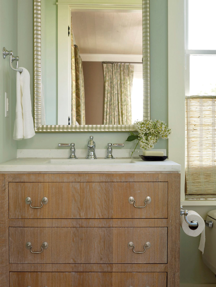 Photo of a transitional bathroom in Charleston with an integrated sink and green walls.