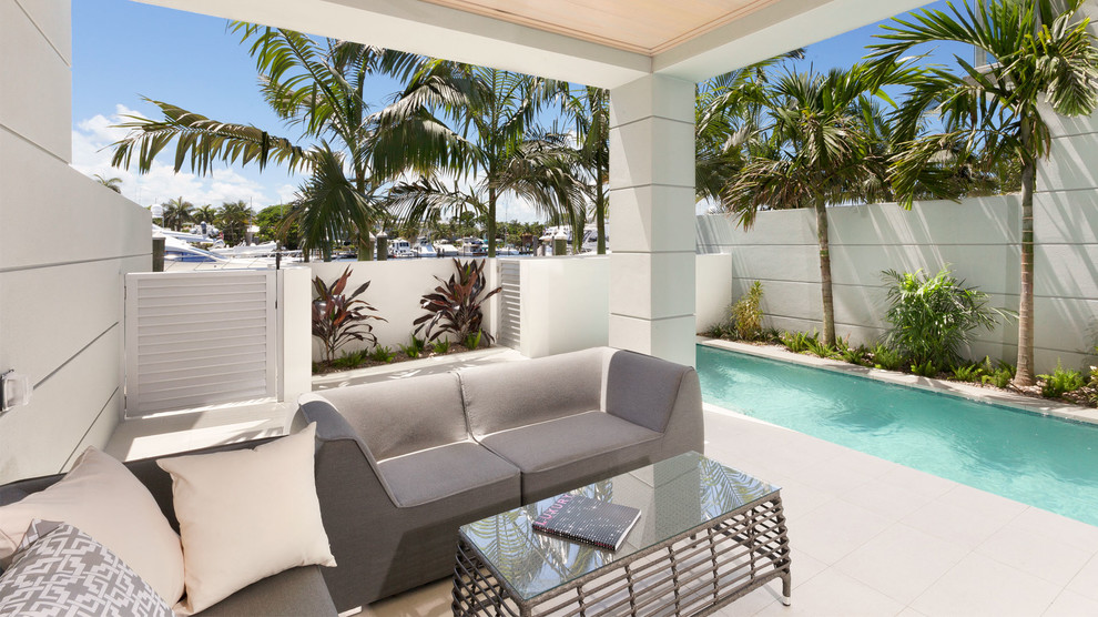 Design ideas for a transitional backyard rectangular pool in Miami.