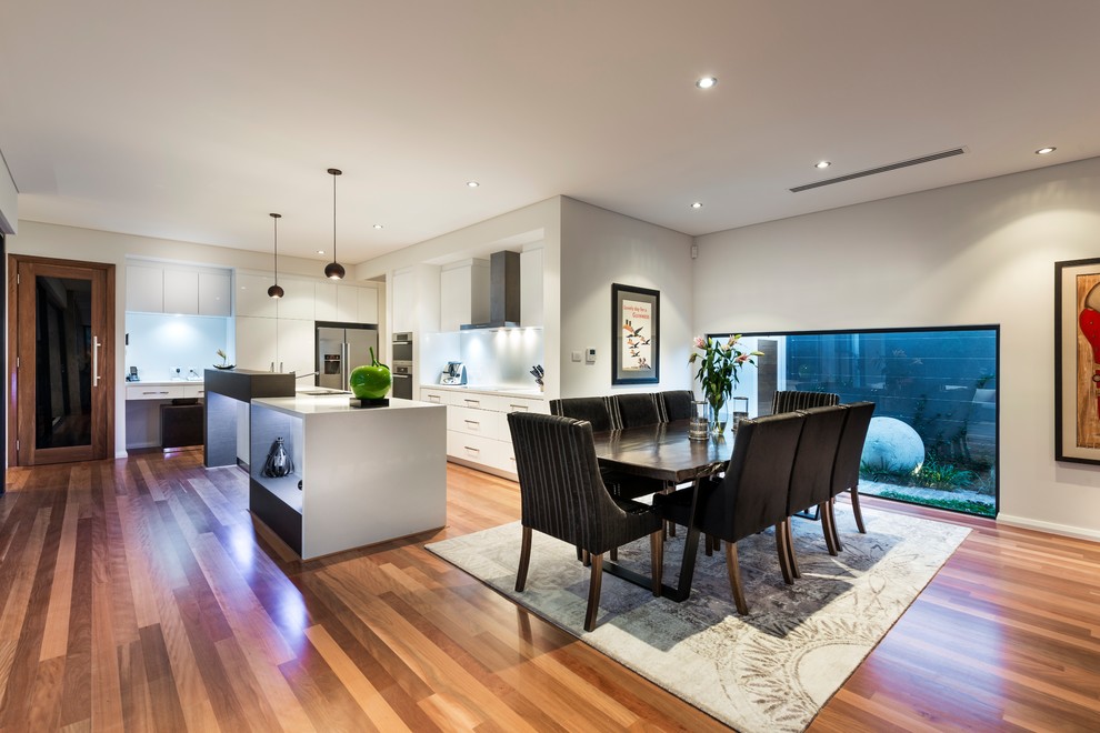 Mid-sized contemporary open plan dining in Perth with white walls, medium hardwood floors, no fireplace and brown floor.