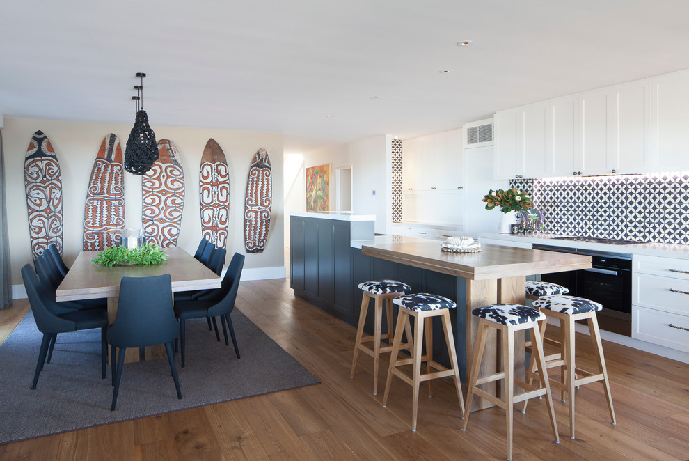Design ideas for a large transitional galley eat-in kitchen in Sydney with a double-bowl sink, shaker cabinets, white cabinets, quartz benchtops, brown splashback, ceramic splashback, stainless steel appliances, medium hardwood floors and with island.