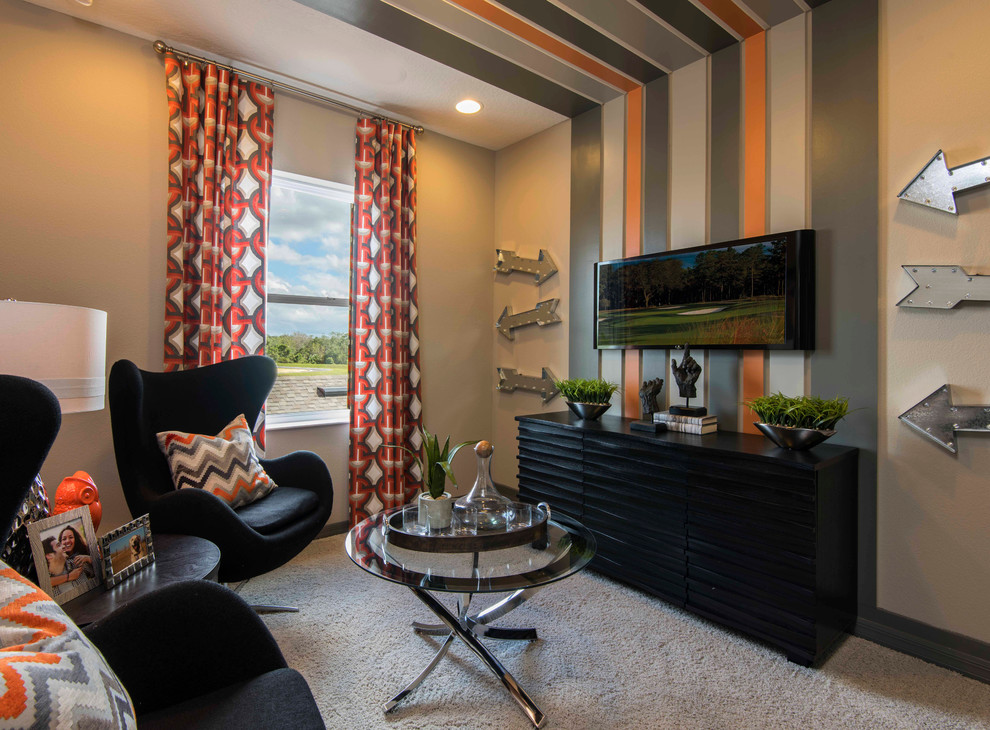 This is an example of a transitional family room in Orlando with multi-coloured walls, no fireplace, a wall-mounted tv and carpet.