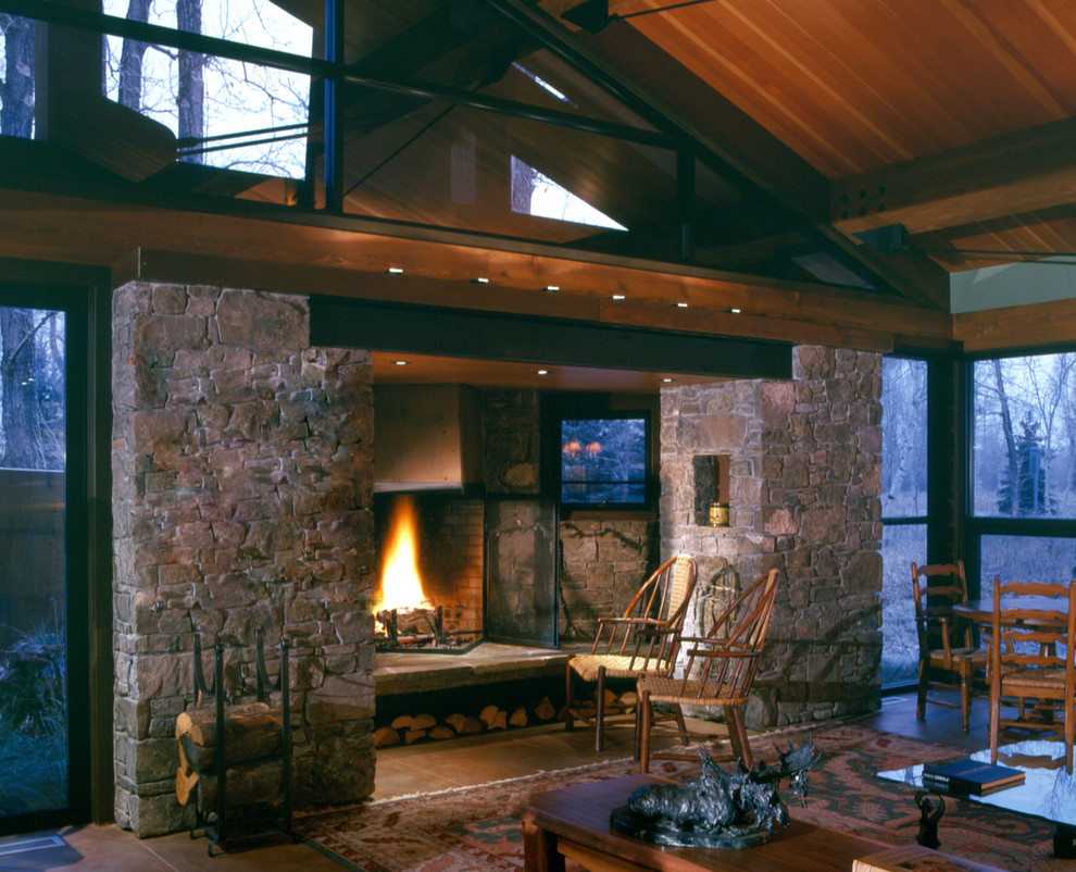 Photo of a large contemporary open concept living room in Other with concrete floors, a wood stove, a stone fireplace surround and brown floor.