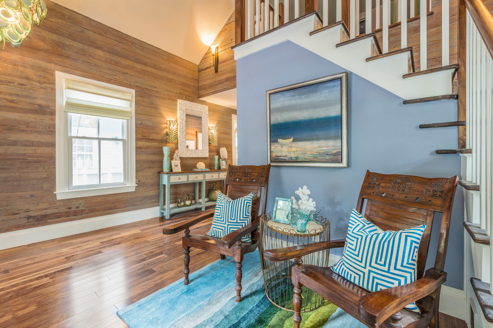 This is an example of a large tropical formal open concept living room in Miami with brown walls, dark hardwood floors, no fireplace, no tv and brown floor.